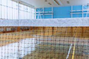 Empty Indoor Sports Arena with Badminton Net, Highlighting Athletic and Recreational Spaces. photo