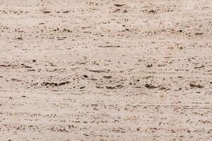 Textured Beige Travertine Stone Background With Natural Patterns and Rough Surfaces. photo