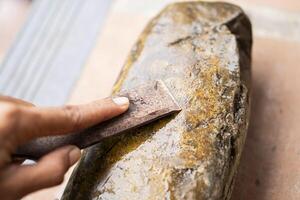 Sharpening a tool on a whetstone photo