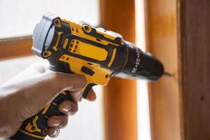 Using a cordless power drill on wood photo