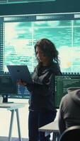 Vertical Governmental hackers execute cyber attacks by breaking passwords, compromising online security. Specialists infiltrate digital networks, breaching security protocols. Cyber surveillance. Camera B. video
