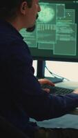 Vertical Cyber security experts in a governmental hacking room working on securing networks. Hackers focusing on malware detection, cyber operations and protection against digital mercenaries. Camera A. video