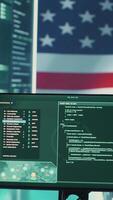 Vertical High tech cybersecurity room with American flag shown on big screen, governmental cyber operations. Data protection, global surveillance and cyber intelligence to guard national security. Camera A. video