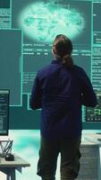 Vertical Group of professional hackers gaining access into government database to steal important information for hybrid warfare. Experts work on scams and phishing activity in high tech office. Camera A. video