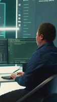 Vertical Governmental hackers using advanced software to protect against cyber threats, working in team. Specialists on cyber security, data and network protection unite forces in high tech office. Camera A. video