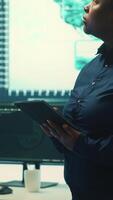 Vertical Governmental hackers working on computer network in high tech office, focusing on data security and cyber operations. Cybercrime, data protection and threat detection in secure environment. Camera A. video