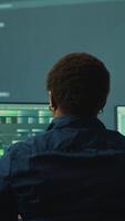 Vertical Governmental hackers analyzing big data for cyber threat detection, working at agency desks. Professional expert woman analyzes cyber intelligence and prevention of digital threats. Camera A. video