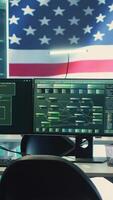 Vertical High tech governmental cyber operations center with USA flag. Network security, cyber defense and global surveillance to protect national security. Hacking tools for digital defense. Camera A. video