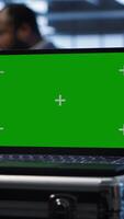 Vertical Isolated screen laptop in data center running error checking software monitoring hardware bugs. Close up of mockup notebook in server hub workspace checking for network issues, camera A video