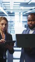 Vertical Manager in data center supervising worker running error checking utilities to fix errors. Supervisor in server farm overseeing engineer repairing network issues affecting rigs performance, camera B video