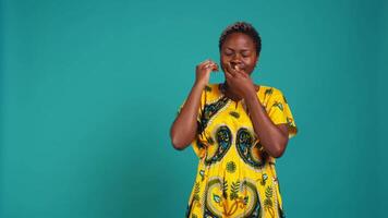 Fatigued girl suffering from burnout and sleep deprivation in studio, yawning and being extremely tired against blue background. Exhausted woman feeling overworked and lazy. Camera B. video