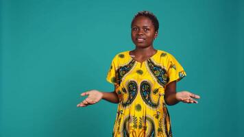 Uncertain woman acting confused and raising shoulders in studio, being clueless and making an i dont know sign. Indecisive unsure person feels doubtful, something ambiguous. Camera B. video