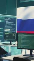 Vertical Empty autocracy cyber defense room with Russian flag running on big screen, showcasing the threat of cyberterrorism and propaganda. Activities of Russian hackers to spread fake news. Camera B. video