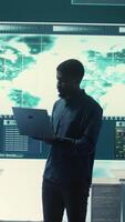 Vertical Cyber security team investigates governmental hacking malware attack on internet servers, high tech office. Cybercriminals hack computer systems, threatening account database protection. Camera B. video