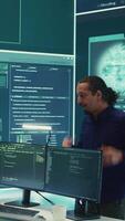 Vertical Governmental cyber defense team using advanced technology to secure information, cyber operations in high tech monitoring center. Working on data protection and threat detection. Camera B. video