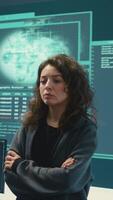 Vertical Cyber security expert in a national safety operations center detecting cyber attacks or threats. Governmental hacking team focusing on data protection, cyber operations in progress. Camera B. video