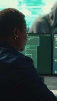 Vertical Cyber security expert working on encryption and IT security in a governmental agency. Woman engaging on cyber operations, network security and data protection for hybrid war. Camera A. video