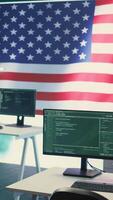 Vertical Empty cybersecurity operations center featuring an American flag. Highlighting IT, digital security and advanced technology for secure computing and cyber intelligence. Hybrid warfare. Camera B. video