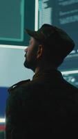 Vertical Military hacker from Russian army working in governmental control room cracking rival states network systems to spread fake news and hybrid war propaganda. Brainwashing ideology strategy. Camera A. video