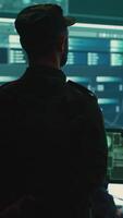 Vertical US military man supervising threat detection activity in high tech office, examining top secret data on big screen. Governmental soldiers managing hybrid war, cyber attack prevention. Camera A. video