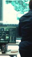 Vertical Governmental hackers exploiting network systems in high tech office, executing cyber operations for national server security. Focus on data protection and online safety to combat cybercrime. Camera A. video