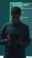 Vertical Cyber intelligence team defending against cyber threats and espionage. Governmental hacker using advanced technology to access information and secure networks, monitors high tech facility. Camera A. video