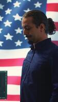Vertical An American hacker in a governmental cyber defense room, showcasing advanced technology and hacking tools. Working on cybersecurity monitoring, digital security and national security. Camera A. video