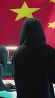 Vertical Terrorist person in a Chinese cyber security room hacking national systems, reading fake news and hybrid warfare propaganda. Digital mercenary group spread misinformation and falsification. Camera A. video