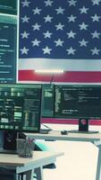 Vertical Cyber intelligence and secure operations center with USA flag on big screen. Highlighting governmental cybersecurity strategy, digital forensics and protection against cyber threats. Camera A. video