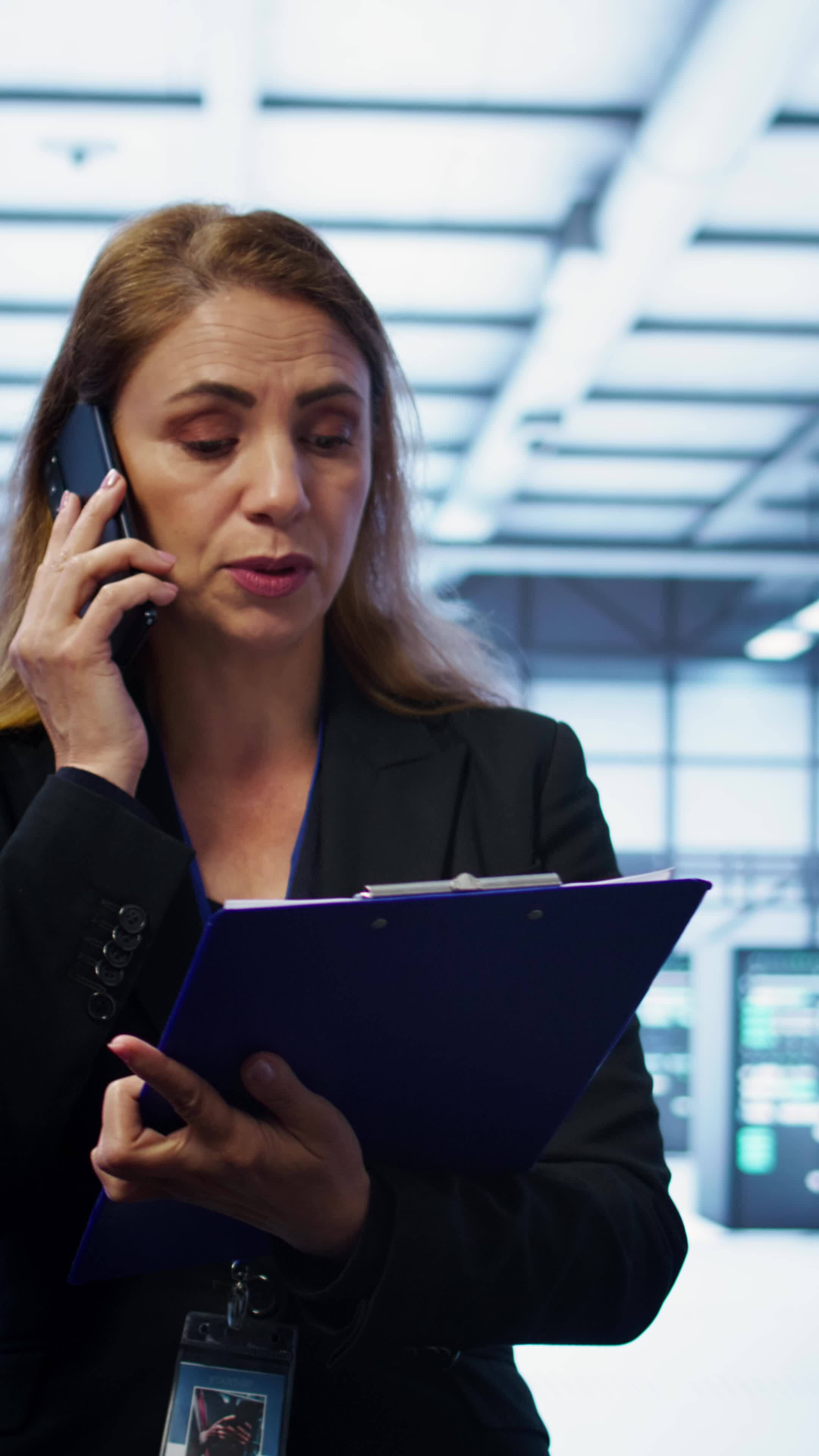 Vertical it specialist looking over data center maintenance checklist