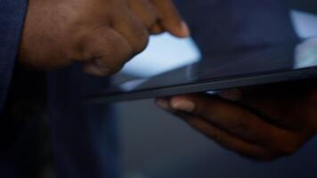 Software developer doing yearly maintenance using tablet to prolong data center equipment life span. Extreme close up of worker in server hub monitoring server infrastructure using device, camera A video