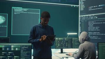 Cyber intelligence team defending against cyber threats and espionage. Governmental hacker using advanced technology to access information and secure networks, monitors high tech facility. Camera B. video