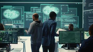 Cyber investigation team working in a governmental hacking room, working on computer security and phishing detection. Emphasizing online security, digital threats and malware prevention. Camera B. video