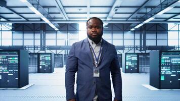 IT expert managing data center with advanced technology, ensuring cybersecurity and efficient network management. Admin in server room maintaining and optimizing data center infrastructure, camera B video