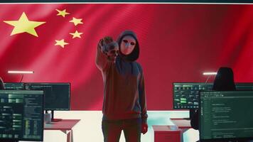 Chinese man presenting a human skull to make death threats, symbolizing criminal activity. Hacker asking for ransom after breaking into governmental security systems, digital mercenary work. Camera B. video