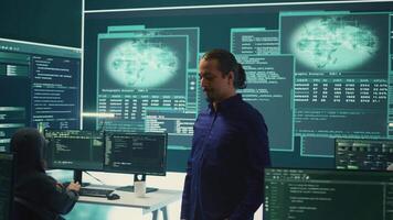 Hacking group targeting network security in governmental office, cyber attacks. Digital security specialists monitoring cyber operations and surveillance, preventing illegal activities. Camera B. video
