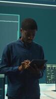 Vertical Cyber intelligence team defending against cyber threats and espionage. Governmental hacker using advanced technology to access information and secure networks, monitors high tech facility. Camera B. video