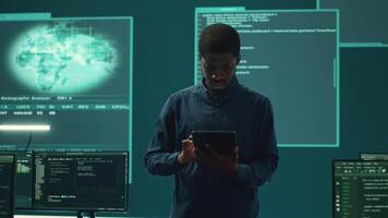 Cyber intelligence team defending against cyber threats and espionage. Governmental hacker using advanced technology to access information and secure networks, monitors high tech facility. Camera A. video