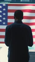 Vertical Cyber defense experts in a governmental tech room with the American flag. Working on secure computing, digital forensics and cyber operations to protect and maintain cyber safety. Camera B. video