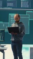 Vertical Governmental hackers breaching network security with advanced techniques, cyber defense in action. Team of IT experts working on gaining access to collect information, big screen. Camera B. video