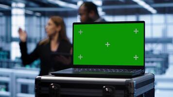 Isolated screen laptop in data center running error checking software monitoring hardware bugs. Close up of mockup notebook in server hub workspace checking for network issues, camera A video