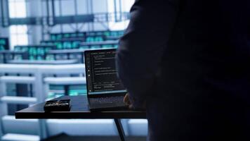 Engineer in server hub works with artificial intelligence computerized model simulating human brain. Man working on laptop with AI machine learning algorithms using pattern recognition, camera A video