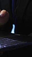Vertical Programmer in server hub checking recovery plan on laptop, monitoring energy consumption across mainframes. Close up of employee using notebook in data center, ensuring rigs are functioning, camera A video