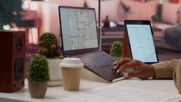 Professional entrepreneur examining blueprints and using digital tools for office space planning and development. Business owner workspace design for renting, investment strategy. Camera A. video