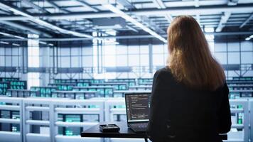 Person in data center works with artificial intelligence technology simulating human brain. Woman working on digital device with AI machine learning algorithms using pattern recognition, camera B video