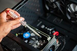 Assembling or repairing a computer with a screwdriver photo