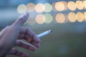A man with a cigarette enjoys smoking photo