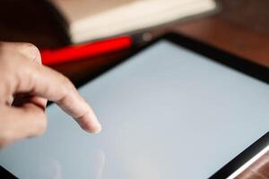 Hand using a tablet with a blank screen photo