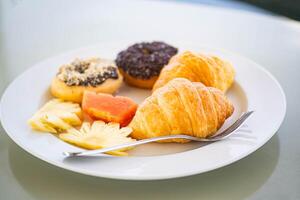 Breakfast plate with pastries and fruits photo