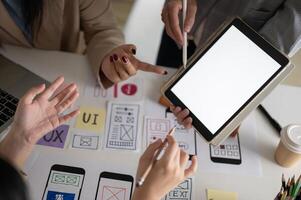Close-up image of a graphic designer team is in the meeting, looking at a digital tablet screen. photo
